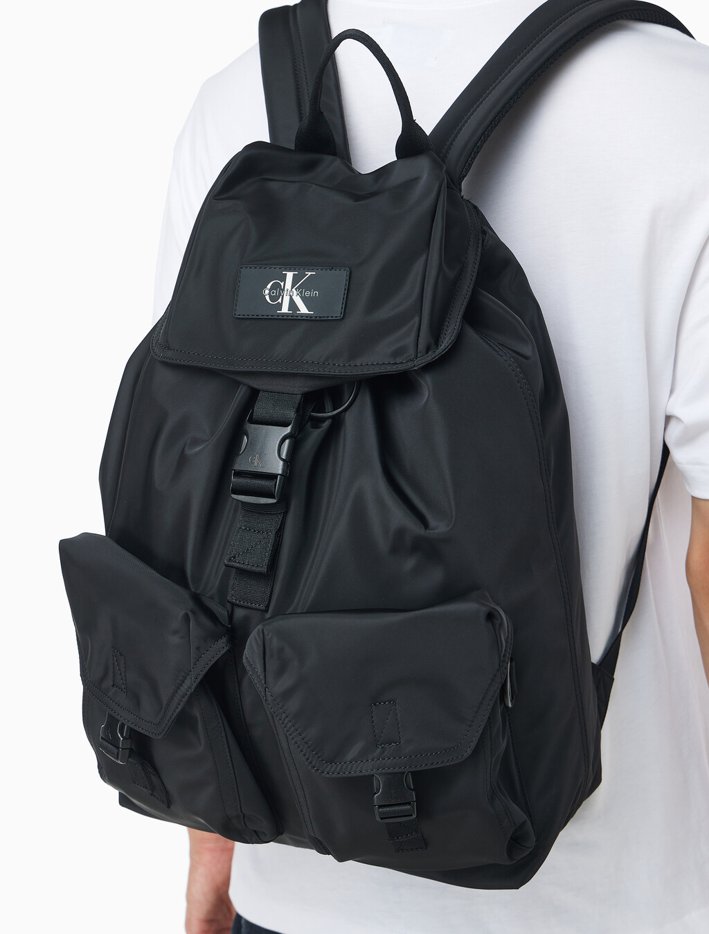 Buy CKJ 리버서블 플랩 투포켓 백팩 in color BLACK