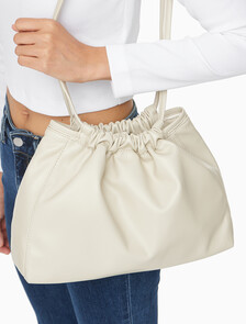 Buy 여성 CKJ 드로우스트링 숄더백 in color BEIGE