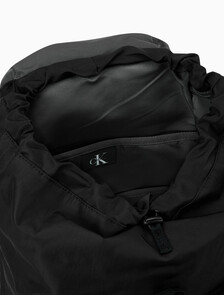 Buy 남녀공용 볼드 로고 나일론 플랩 백팩 in color BLACK